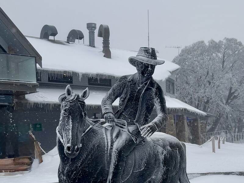 The Man from Snowy River bronze in the village, horse and rider glazed over with ice.