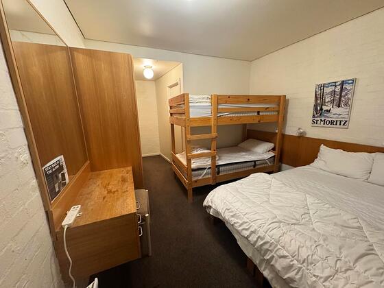Room 4: a single-over-single bunk beside a queen bed, built-in wardrobe with mirror.